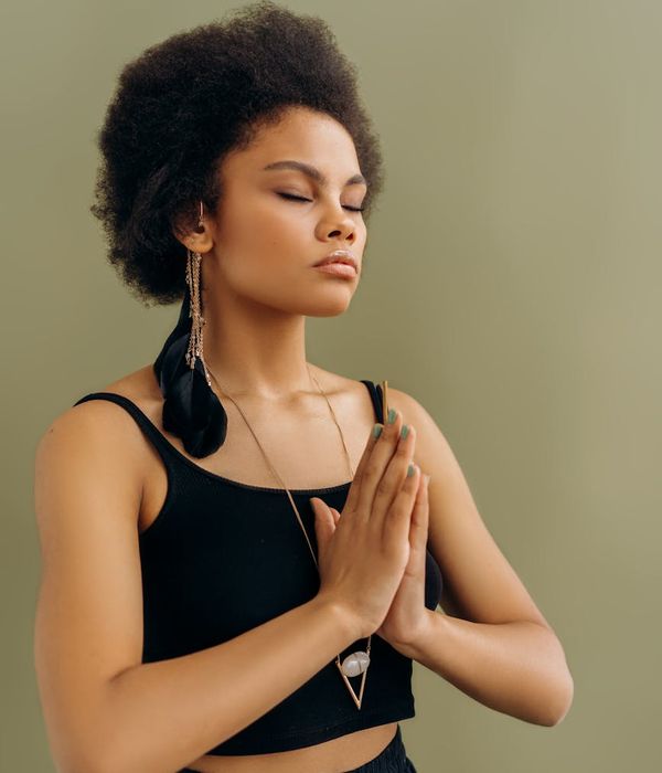Woman practicing a peaceful yoga pose in a calm studio.